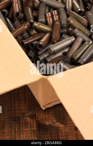 Shotgun cartridges in box on wooden table close-up Stock Photo