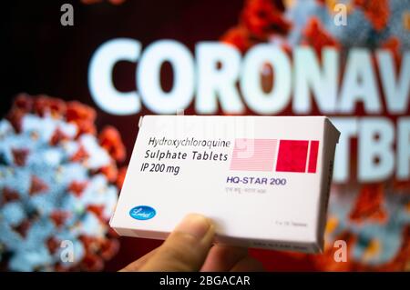 Hydroxychloroquine Sulphate tablets with coronavirus written in background Stock Photo