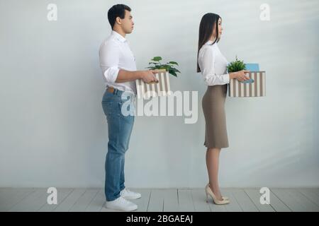 Man and woman holding boxes in their hands Stock Photo