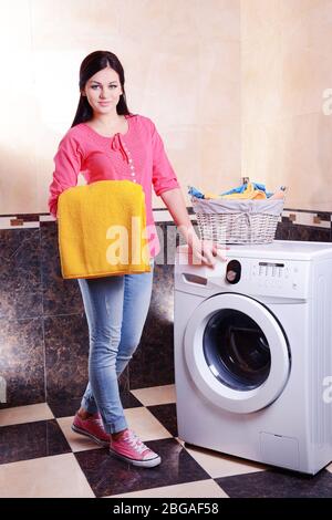 Beautiful young woman erases in house Stock Photo