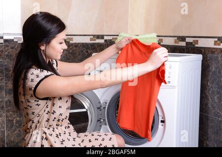 Beautiful young woman erases in house Stock Photo