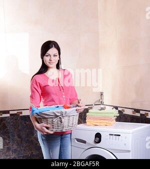 Beautiful young woman erases in house Stock Photo