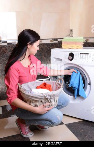 Beautiful young woman erases in house Stock Photo