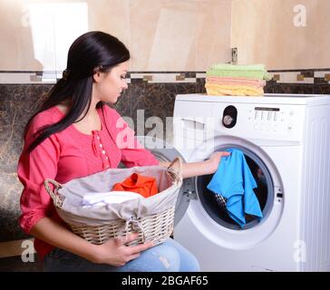 Beautiful young woman erases in house Stock Photo