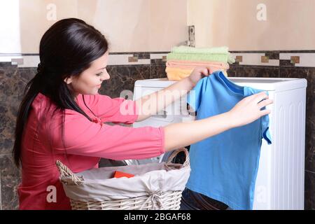 Beautiful young woman erases in house Stock Photo