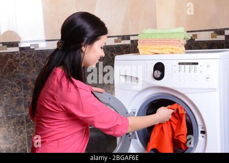 Beautiful young woman erases in house Stock Photo