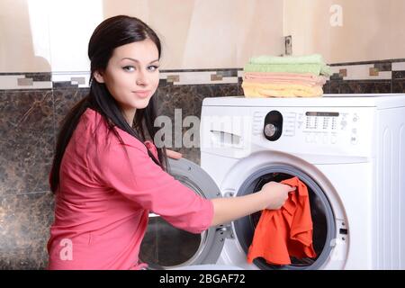 Beautiful young woman erases in house Stock Photo