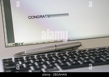 Congrats, typed words on the computer screen. Good news on new job or promotion concept. Stock Photo