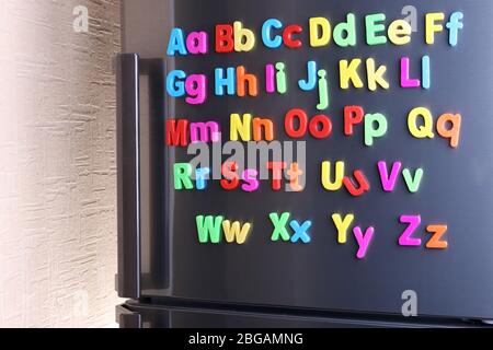 Colorful magnetic letters on  refrigerator Stock Photo