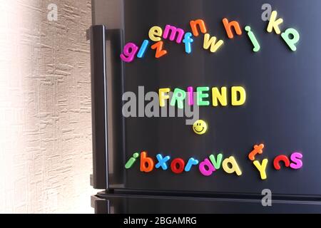 Word Friend spelled out using colorful magnetic letters on refrigerator Stock Photo
