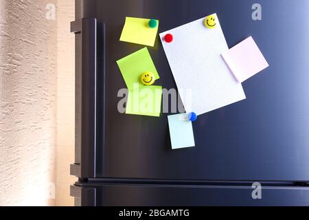 Empty paper sheets on fridge door Stock Photo