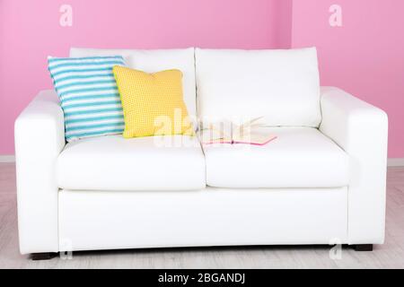 White sofa in room on pink background Stock Photo