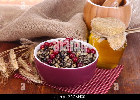 Bowl with kutia -  traditional Christmas sweet meal in Ukraine, Belarus and Poland, on wooden background Stock Photo