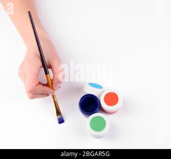 Hand holding brush with paints isolated on white Stock Photo - Alamy