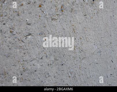 Texture background texture of gray concrete, with remains of brick and iron. Cracks and damage to concrete. Stock Photo