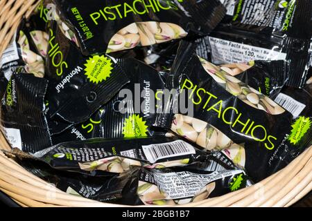 Pistachio nut packages in a wicker basket. Wonderful brand pistachio nuts are currently the best selling in the USA. The company formed in 2015. Stock Photo