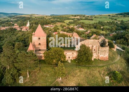 Aerial drone view of Slimnic Fortress (Stolzenburg), located on a Burgbasch hill on a Sibiu-Mediaș road in Transilvania, Romania. Travel spots in Roma Stock Photo