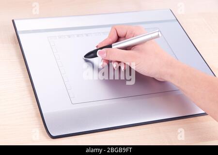 Female hand using graphics tablet on table close up Stock Photo