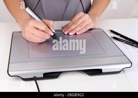Female hand using graphics tablet on table close up Stock Photo