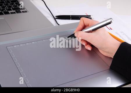 Female hand using graphics tablet on table close up Stock Photo