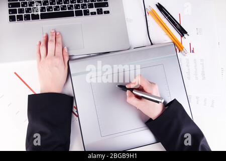 Female hand using graphics tablet on table close up Stock Photo
