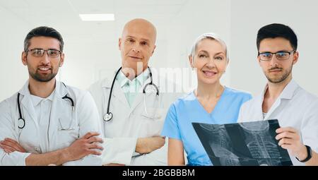 team of doctors and nurses standing at clinic. group of medical staff looking at camera Stock Photo