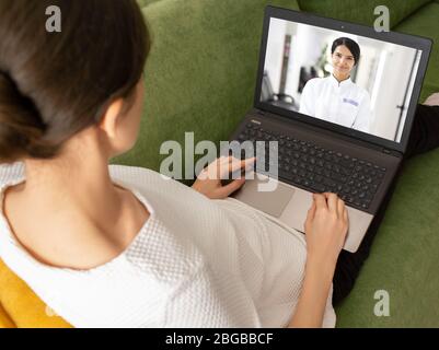 woman having online consultation with her doctor. doctor explain result of analysis to her patient using video chat. Stay home Stock Photo