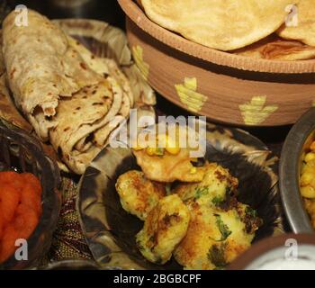 chole tikiya, fried potato,chapatti served in disposable plate made from dry leaf pure villagers style delicious street food Stock Photo