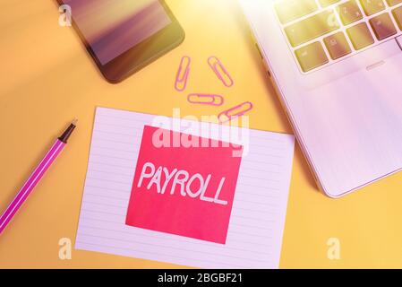 Handwriting text writing Payroll. Conceptual photo Total amount of money company pays to employees Salary Payment Trendy laptop smartphone marker pape Stock Photo