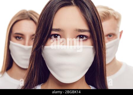 Young people in protective face masks isolated on white. Stock Photo