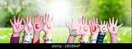Kids Hands Holding Word Viel Glueck Means Good Luck, Grass Meadow Stock Photo