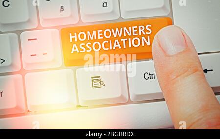 Handwriting text writing Homeowners Association. Conceptual photo Organization with fee for upkeeps of Gated Community Stock Photo