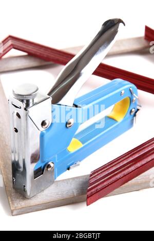 Fastening wooden frame using construction stapler isolated on white Stock  Photo - Alamy