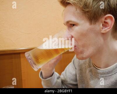 A handsome young man enjoying his beer Stock Photo