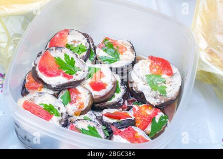Fried eggplant in mayonnaise with garlic and pieces of red fish Stock Photo