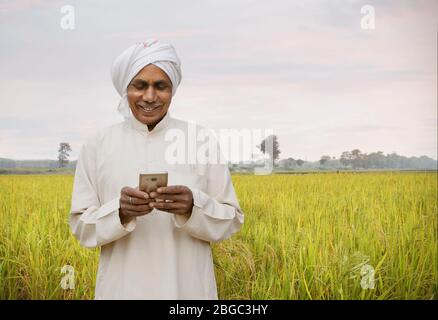 farmer with cellphone smiling Stock Photo