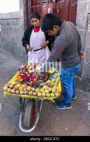 Street vendor selling produce at San Pedro Market in Cusco, Peru Stock Photo