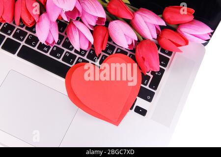 Red hearts and flowers on computer keyboard close up Stock Photo