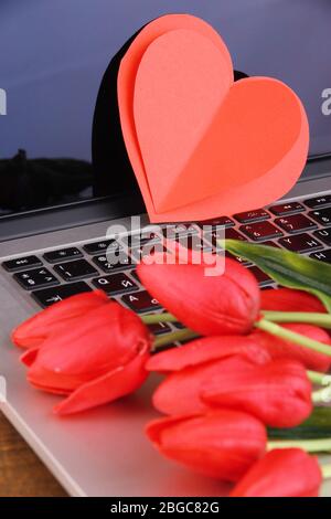 Red hearts and flowers on computer keyboard close up Stock Photo