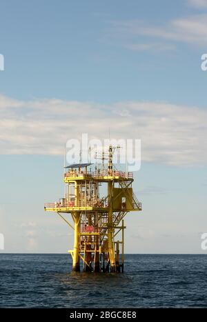 oil rig platform drilling at sea during sunset Stock Photo