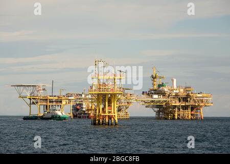 accommodation work boat attach to oil platform at sea form scheduled maintenance