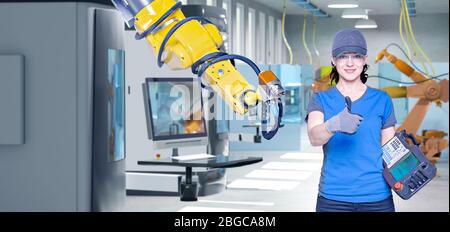 A young female technician while machine constructing in a manufacturing plant Stock Photo