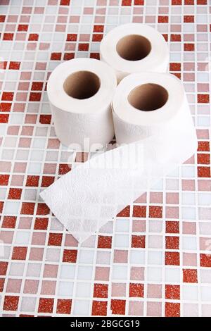 Color toilet paper rolls on bright background Stock Photo