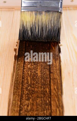 Applying protective varnish to wooden board close-up Stock Photo