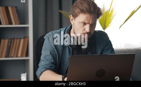 Serious man using laptop Stock Photo