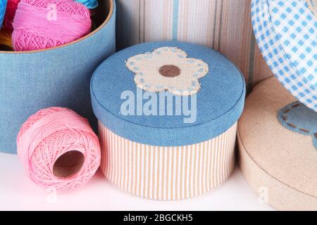 Decorative boxes with colorful skeins of thread close up Stock Photo