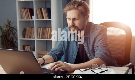 Busy man working from home Stock Photo