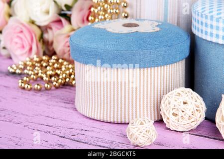 Decorative boxes with flowers on wooden background Stock Photo