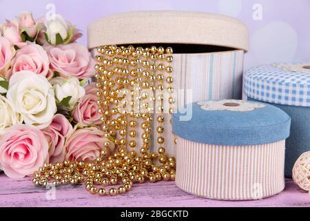 Decorative boxes with flowers on table on bright background Stock Photo