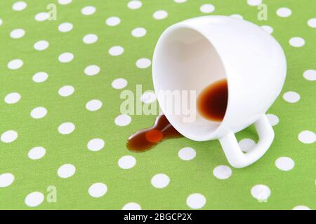 Overturned cup of coffee on table close-up Stock Photo